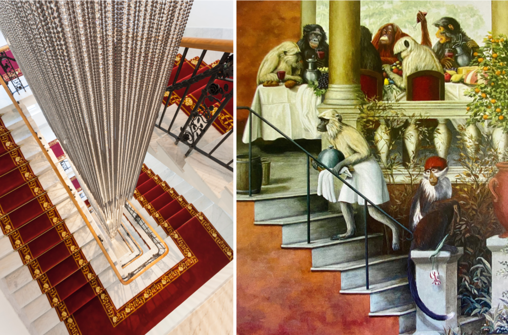 impressive chandelier and elevator shaft paintings depicting monkeys at a dinner table